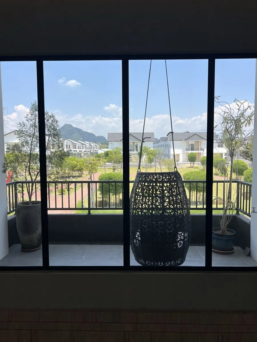 Balcony with hanging chair and hill views at BungalowDees Premier