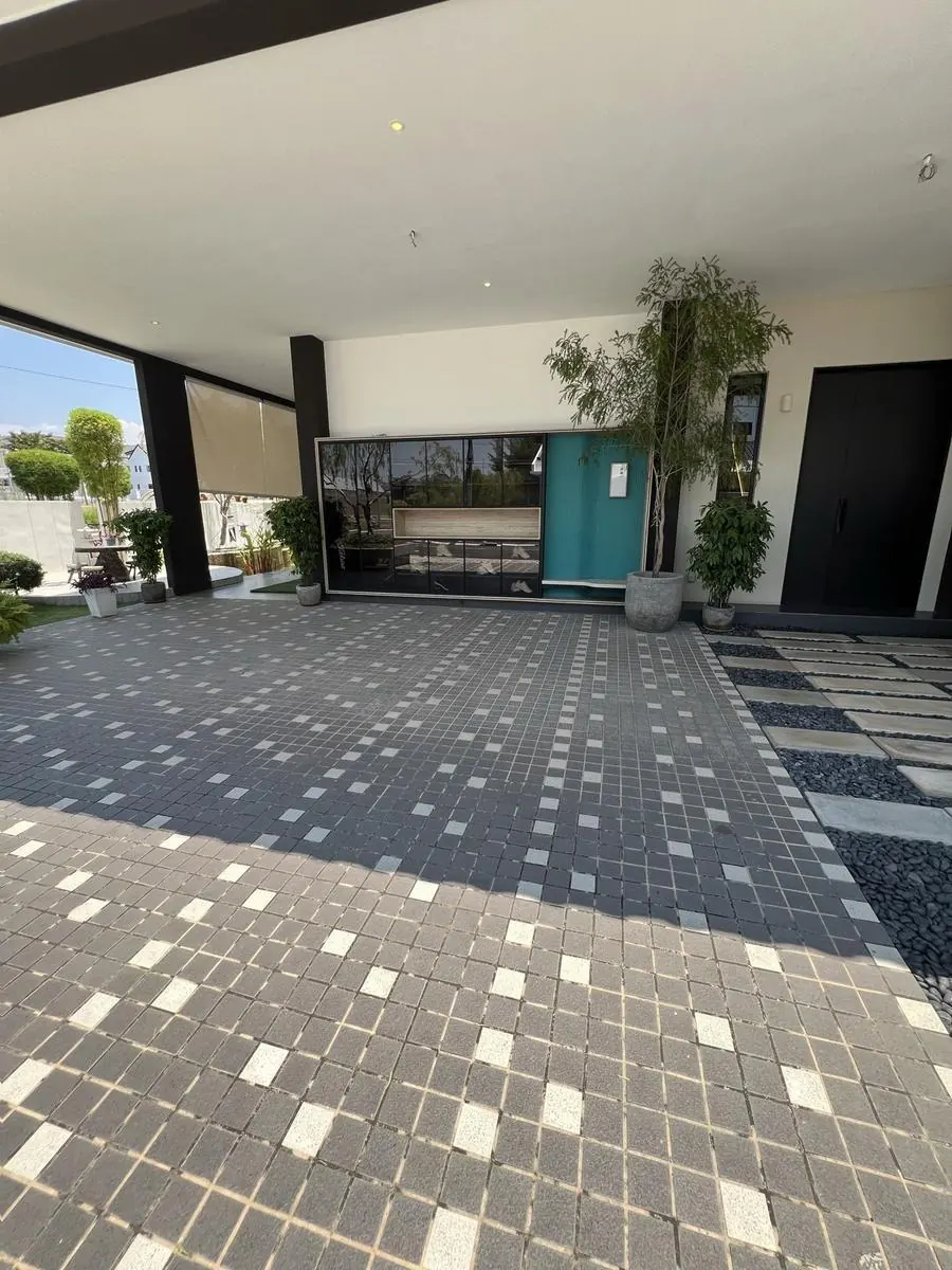Car porch and patterned driveway at BungalowDees Premier